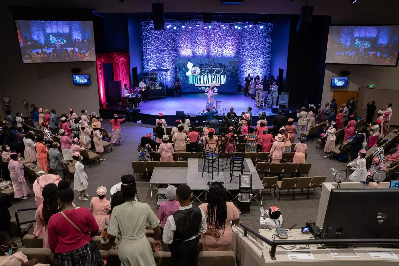 Apostolic church gathering with a large group of people in pink robes.